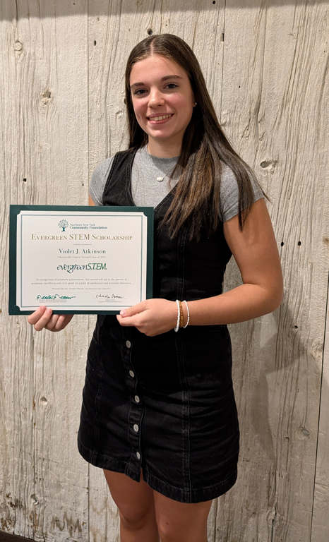 HCS senior holds up certificate.