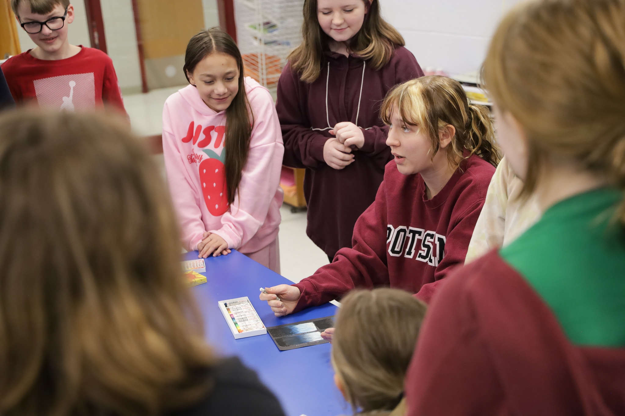 A group of high school students works on a project together.