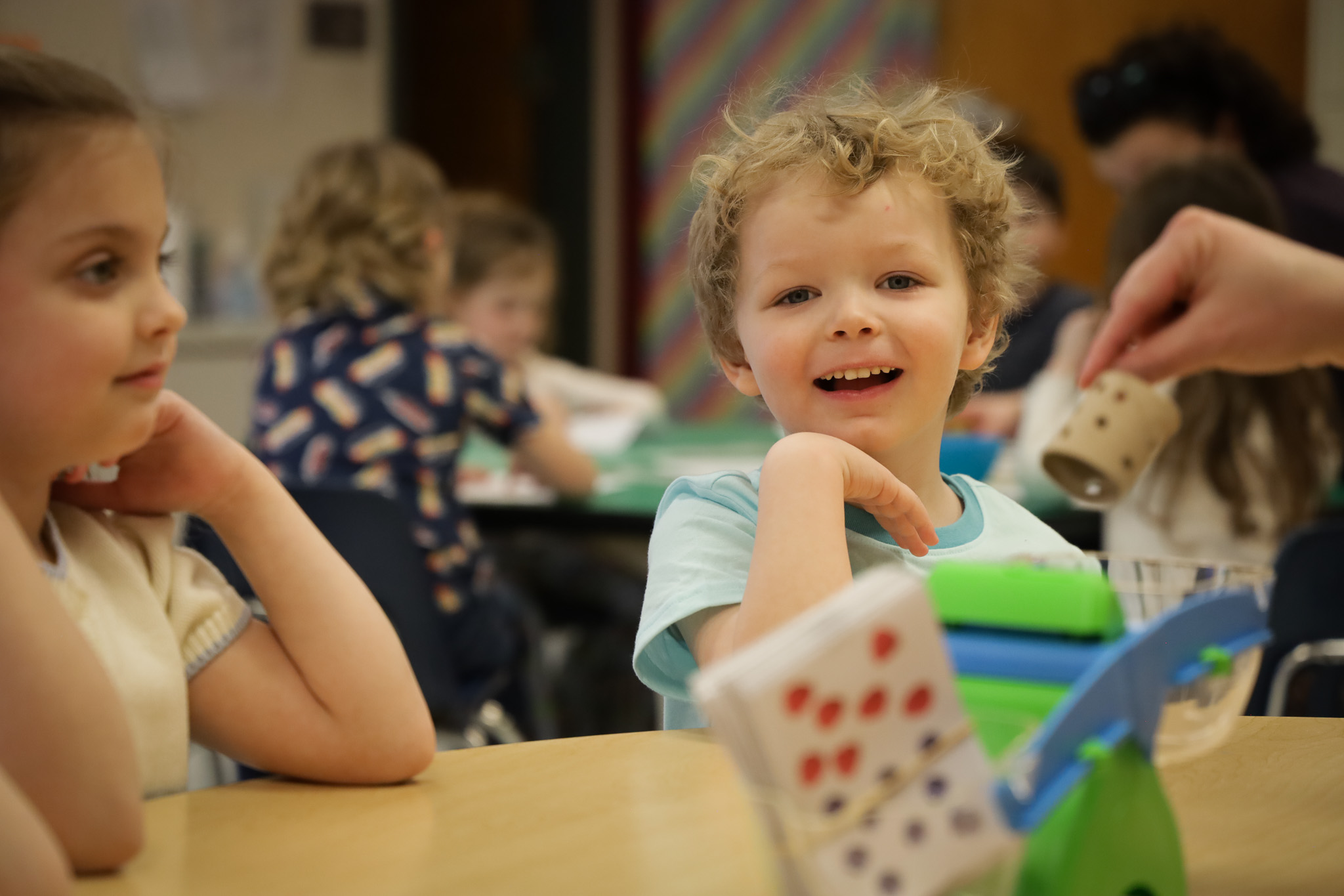 Two students smile in class.