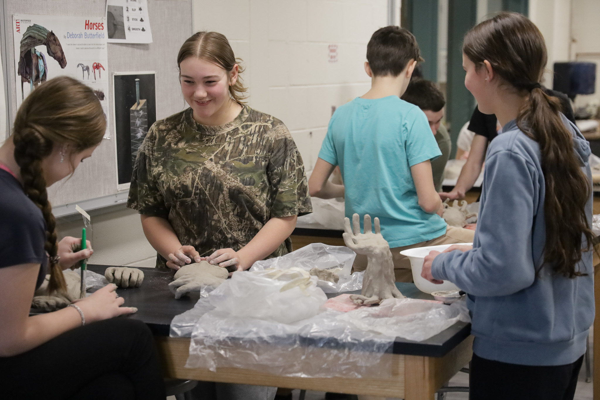 Students work with clay in art class.