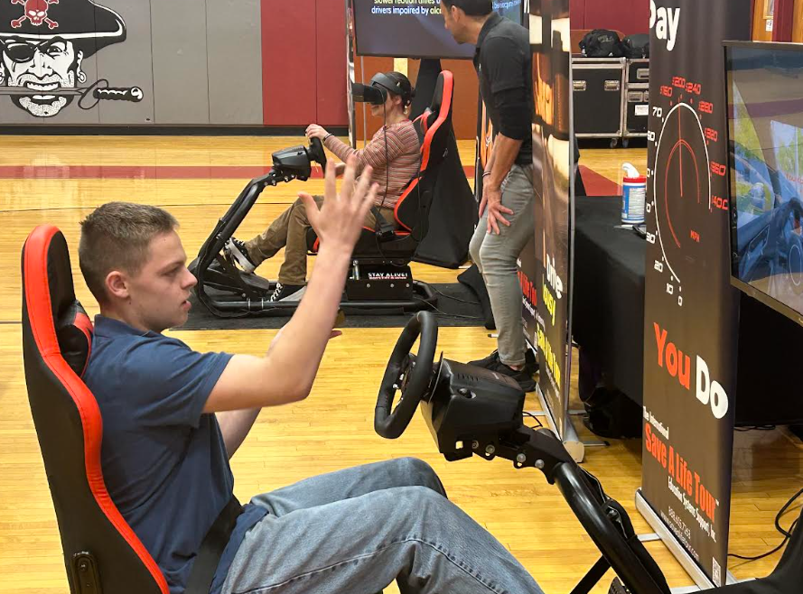 Student sits in distracted driving simulator at HCS.