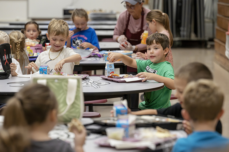 Students eat lunch in the cafeteria.