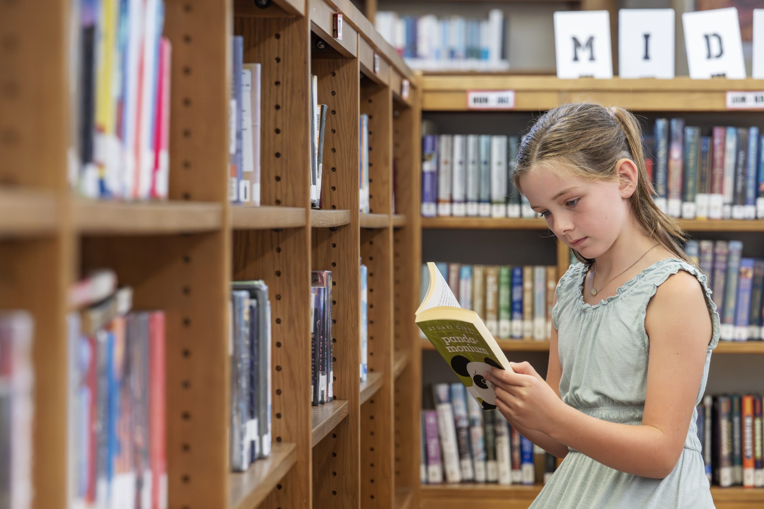 A student reads a book in the library.